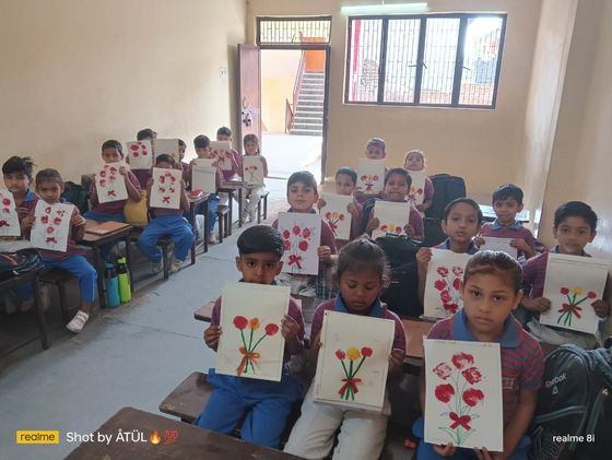 Primary students with their artwork at Gandhi Public School