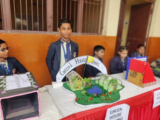 A student presents a science model at the school exhibition